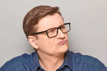 Portrait of thoughtful serious mature man with glasses