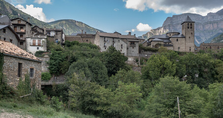 Fototapeta na wymiar View of Torla-Ordesa village, located in a glacial valley of Ara river, the gateway to the Spanish Pyrenees, Ordesa and Monte Perdido National Park, Province of Huesca, Aragon, Spain.