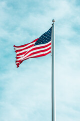 Isolated American flag blowing in wind