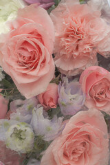 Flower vertical background 
behind the misted glass with pink roses,
carnation and blue flowers