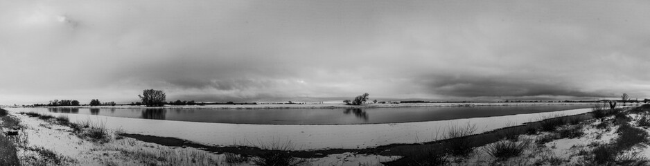 nearly b&w panorama of a winter river