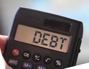 debt word on calculator display. Financial obligations business crisis concept