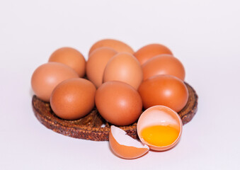 Fresh chicken eggs are placed on a rattan stand.