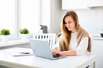 Woman in front of laptop monitor during online conversation. Remote working.