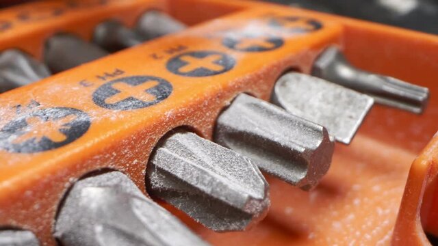 extremely close-up, detailed. drill bits in orange toolbox.