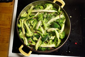 Broccoli cut and put in a pan with oil and onion