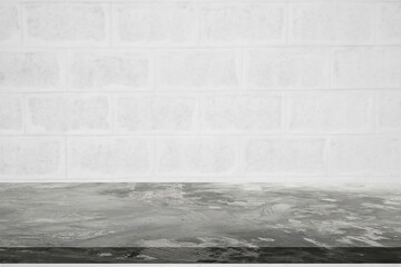 Concrete floor or table empty on white brick background. Concept to place products such as cement, steel, or other construction-related products. Or Place food-related items such as meat, vegetables.