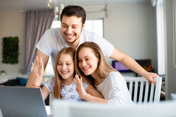 Happy american family having online meeting with relatives. Family in front of laptop monitor.