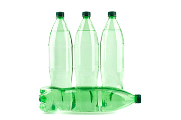 Plastic bottles with mineral water on a white background. One bottle lies horizontally on a white background. Copy space.