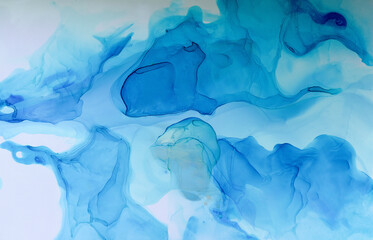 Abstract blue background, wallpaper. Mixing acrylic paints. Modern art. Marble texture. Alcohol ink colors translucent