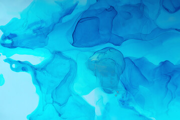 Abstract blue background, wallpaper. Mixing acrylic paints. Modern art. Marble texture. Alcohol ink colors translucent