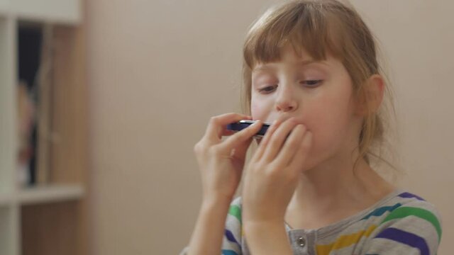 Girl fooling with harmonica home interior