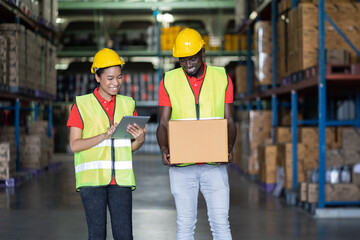 Group of African American male and female warehouse worker moving or transfer products or parcel goods to shelves shelf pallet in storage warehouse. teamwork concept