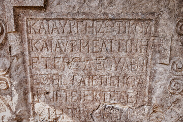 Inscriptions in ancient Greek on an ruined tombstone in a cemetery in Turkish Anatolia