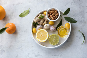 Concept of natural medicine. Natural remedies for colds on grey background. Flat lay. Copy space.
immunity booster food honey garlic ginger citrus und superfoods