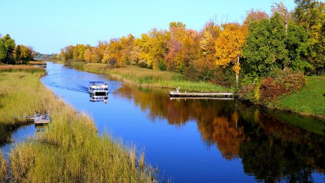Mississippi River and a pontoon in Bemidji Minnesota near highway 2. Beautiful autumn colors in the trees along the river, a few miles from the source at Lake Itasca.
