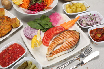 grilled salmon served with corn bread and green salad