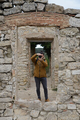 Fototapeta na wymiar Photographer takes pictures through a window of some ruins and wall