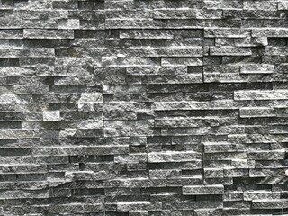 Background of small grey and greyish bricks
