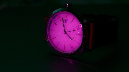 wrist watch captured in low light with a back light support