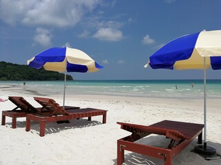Phu Qoc island beach with white sand and sun beds and umbrellas in Vietnam