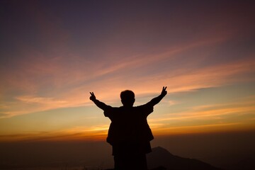 silhouette of person with arms outstretched