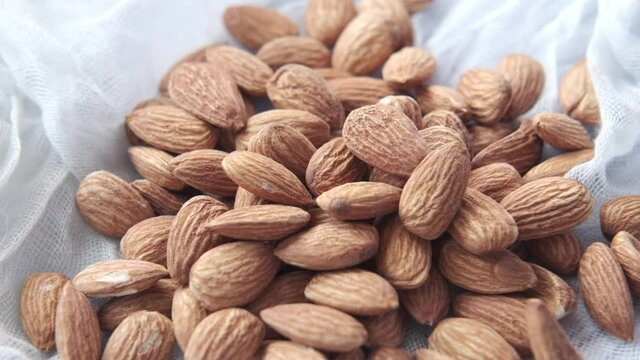 slow motion of dropping almond nuts in a bowl 
