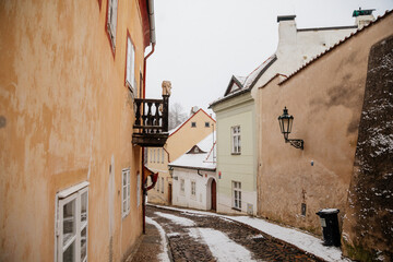 Fascinating narrow picturesque street with baroque and renaissance historical buildings, snow in winter day, Novy svet, New World in vicinity of Hradcany, Prague, Czech Republic