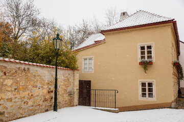 Fascinating narrow picturesque street with baroque and renaissance historical buildings, snow in winter day, Novy svet, New World in vicinity of Hradcany, Prague, Czech Republic
