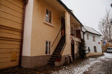 Fascinating narrow picturesque street with baroque and renaissance historical buildings, snow in winter day, Novy svet, New World in vicinity of Hradcany, Prague, Czech Republic