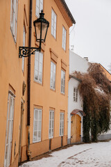 Fascinating narrow picturesque street with baroque and renaissance historical buildings, snow in winter day, Novy svet, New World in vicinity of Hradcany, Prague, Czech Republic