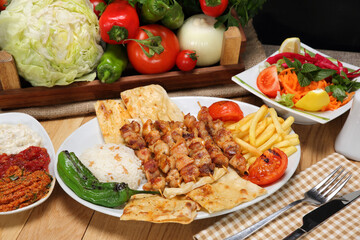 grilled chicken skewers pilaf fried potato and grilled tomato pepper