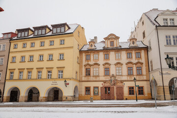 Fototapeta na wymiar Baroque house with painted windows at Loreto Square, national cultural landmark, Hradcany under snow in winter day, Prague, Czech Republic