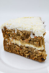 Delicious Slice of a Double Layer Homemade Carrot Cake on a White Plate
