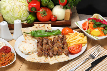 grilled chopped meat skewers pilaf fried potato and grilled tomato pepper