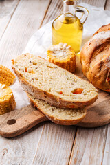 Sliced fresh baked corn and pumpkin bread on the decorated table