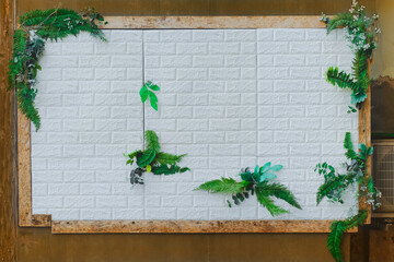 Advertising wood billboard with small plant on copy space.