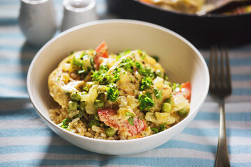 Chicken with peas and red pepper in cream sauce, served with rice 