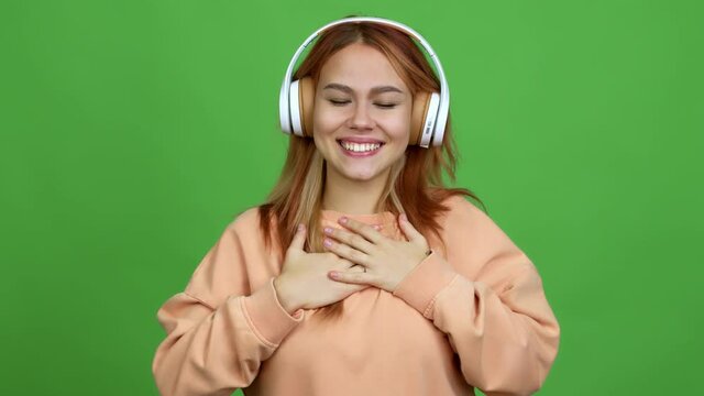 Teenager girl listening music with headphones with surprise and shocked facial expression over isolated background