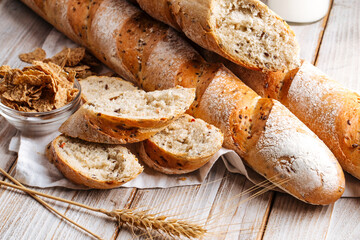 Top view on cereal baguette loafs on the wooden decorated background