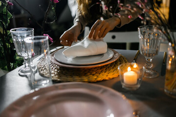 female hands serve a napkin on a table with flowers