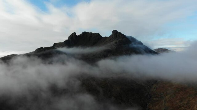 Aerial footage capturing one of Scotland's most iconic mountain summits the Cobbler. Situated in Argyll & Bute in the Scottish Highlands this footage captures it's summit peaking above the clouds.