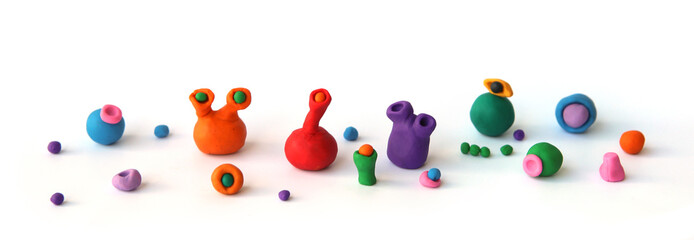 Handmade clay plasticine figurines isolated on white background. Colorful slugs from play dough.