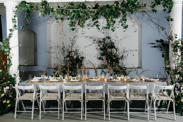 decorated with fresh flowers and served table for a festive dinner indoors