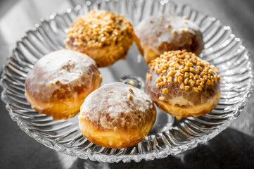  fresh baked donuts with nuts on a epergne (plate)