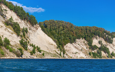 Colorful landscape with a view from a pleasure boat to the blue sky with mountainous terrain