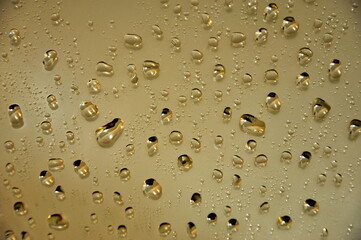 Water drops on the mirror, light brown background.