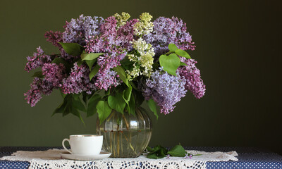 lush bouquet of lilacs in a glass vase.
