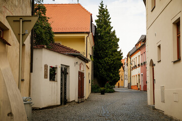 Narrow medieval picturesque street with baroque and renaissance historical buildings in sunny summer day, beautiful cityscape of medieval town, Tabor, South Bohemia, Czech Republic