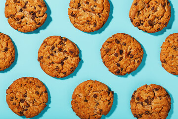 Oatmeal cookies with chocolate chip pattern and patterns on a light blue background.